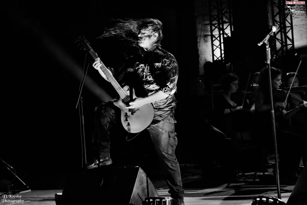 Stage view of Septicflesh live at the Acropolis, blending metal and classical elements.