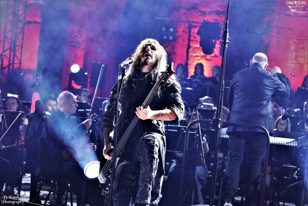 Septicflesh performing live at the Odeon of Herodes Atticus in Athens, with dramatic stage lighting